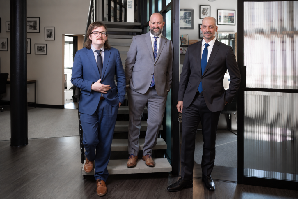 Spencer Aldrich, Zachary Brunot and Collin Armfield on the office stairs